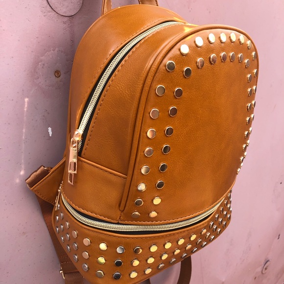 Selling a tan purse with studs surround the purse. - Picture 3 of 4